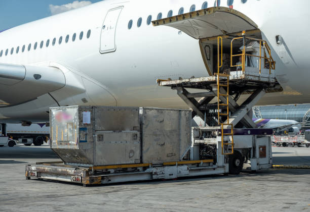 istock Air cargo logistic containers are loading to an airplane. 1220271312