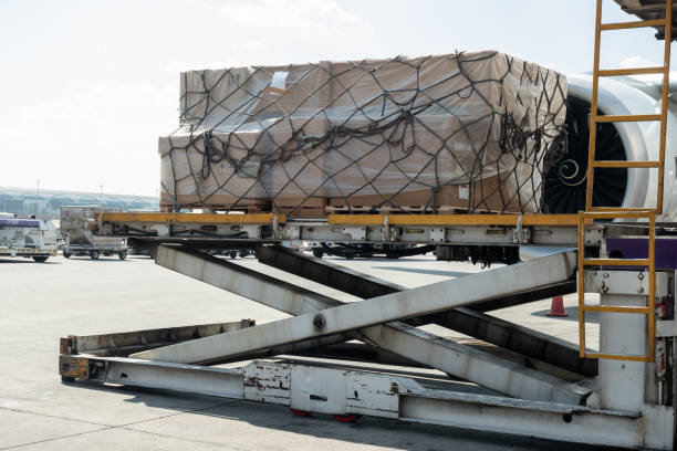 istock Air cargo logistic containers are loading to an airplane. 1220271318