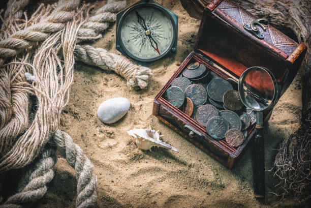 Pirate. Pirate treasure chest with ancient coins and other various pirate equipment on flat lay table background. rifle old fashioned antique ancient stock pictures, royalty-free photos & images