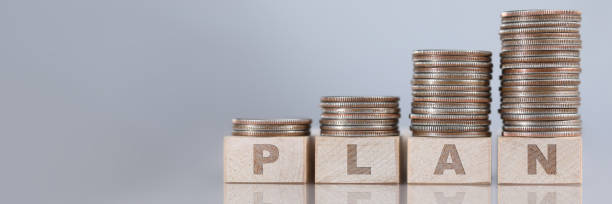 istock Column of silver quarters standing at wooden cubes 1220273195
