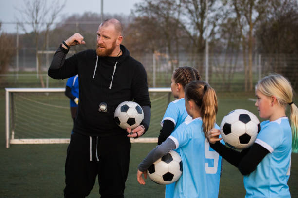 istock Soccer father coaching football daughter's team during a training session 1220273288