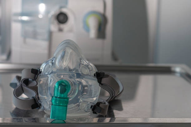 Non-invasive ventilation face mask, on background medical ventilator in ICU in hospital. stock photo