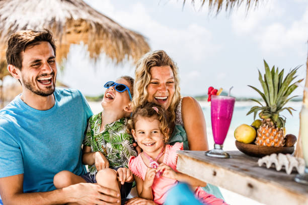 istock Happy parents having fun with their kids in a beach cafe. 1220274068