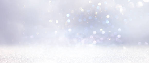 istock glitter vintage lights background. gold, silver and white. de-focused 1220274511