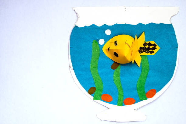 istock Children's application. yellow fish in an aquarium with algae and blue water. 1220276503