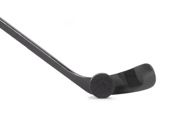 istock Black ice hockey stick and puck. 1220278228