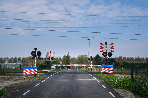 Road signs at the railway crossing with a barrier. Organization of the transport system of a European country. Safety of traffic in road and rail transport, Rotterdam Netherlands