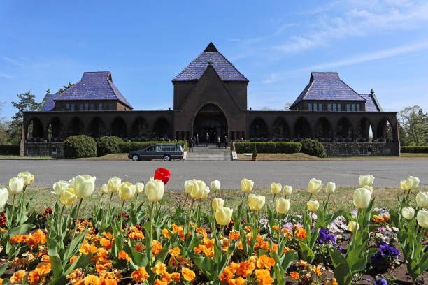 Building of the crematorium with flowers Building of the crematorium with flowers hearse photos stock pictures, royalty-free photos & images