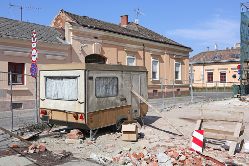 Old ruined caravan trailer at the construction site