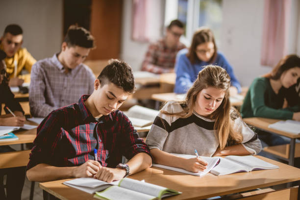 istock Group of high school students writing an exam in the classroom. 1220280678