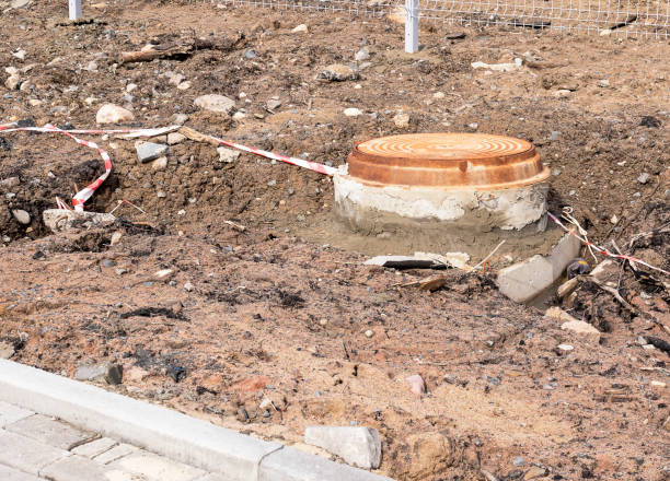 istock sewer manhole on the muddy ground. unfinished construction 1220282929
