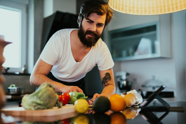 istock Young man preparing vegan meal at home 1220285985