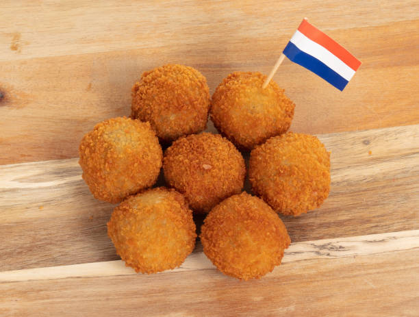 istock Dutch traditional snack bitterbal on a serving board, dutch flag, isolated 1220286067