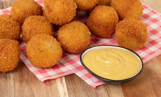 istock Dutch traditional snack bitterbal on a serving board, isolated 1220286088