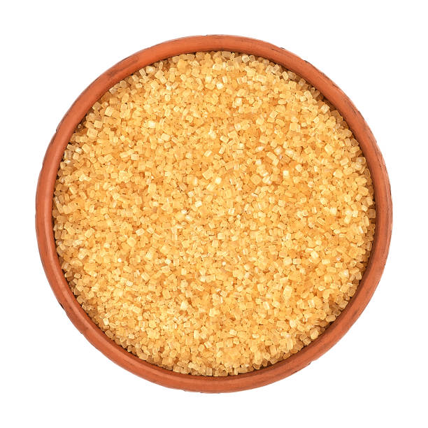 istock Brown cane sugar in a bowl isolated on white background, top view. 1220286620