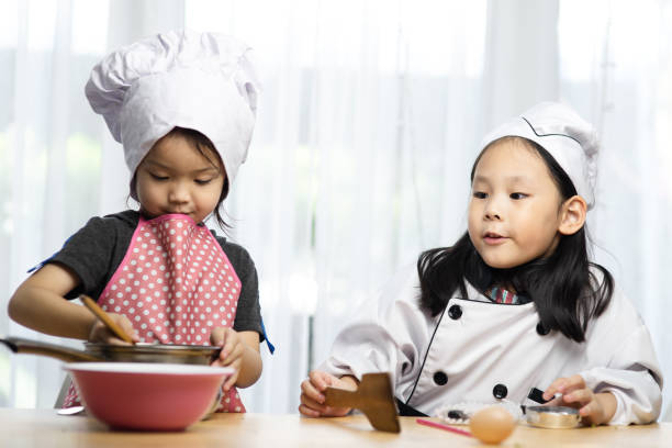 istock Happy Asian girsl playing chef at home. 1220286642