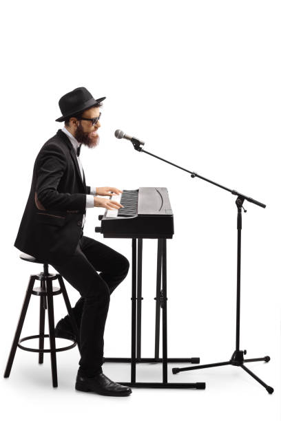 istock Solo musician playing keyboard and singing on a microphone 1220287198