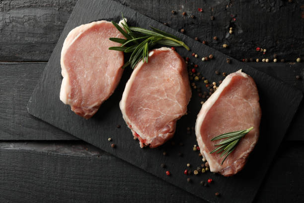 istock Composition with raw meat for steak and spices on wooden background 1220288098