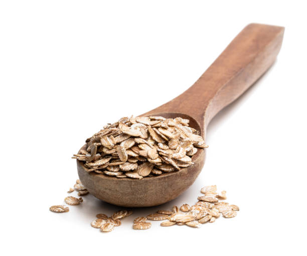 istock Wooden spoon with rye flakes isolated on white 1220288198