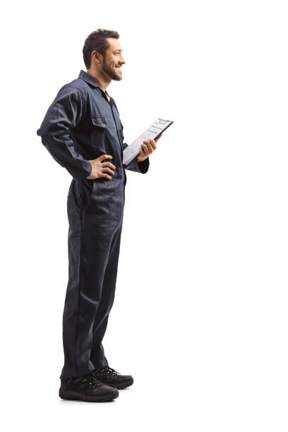 istock Male worker in a uniform holding a clipboard with a document 1220289618