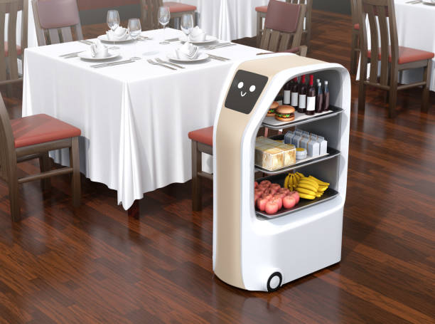 Food delivery robot stopped near a table waiting for picking meals in a restaurant stock photo