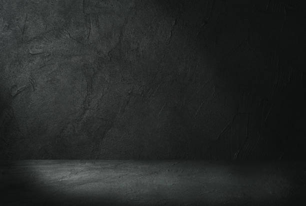 istock Studio dark room concrete floor grunge texture background with light shading. 1220290441