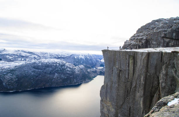 istock man approaches the edge of the preiklestolen 1220290969