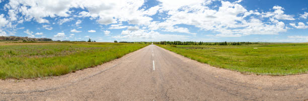 istock A straight asphalt road with meadows on both sides 1220292076