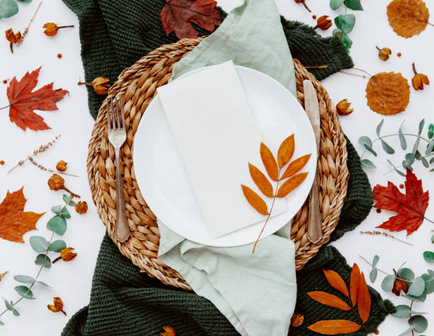 istock Festive table setting with cutlery, eucalyptus branch, porcelain plate. Blank card mockup. Rustic restaurant menu concept. Flat lay, top view 1220294437
