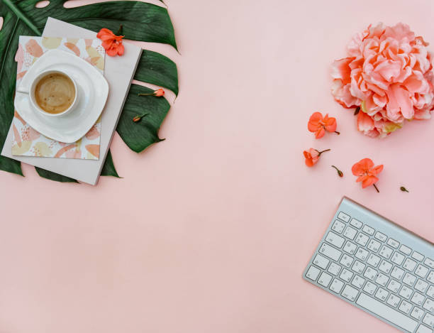 istock Freelancer home office desk workspace with keyboard and coffee cup on pink background. Flat lay, top view still life concept 1220294502