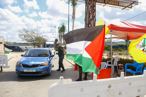a roadblock to enforce movement control order due the coronavirus (Covid-19) with Palestinian flag. Qalqilya, West Bank, Palestinian Territories, Palestine - April 22, 2020