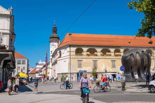 Maribor, Slovenia - August 09, 2019: People on bicycles on Trg Svobode or Liberty Square in Old city Maribor, Slovenia