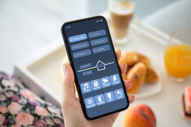 istock female hands holding phone with app smart home on screen 1220296959