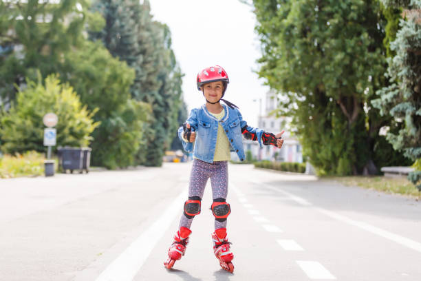 istock Little girl in roller skates at a park 1220298639