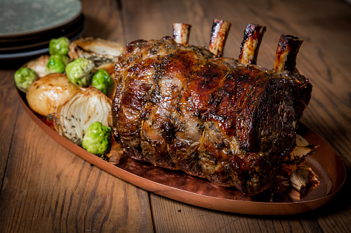 Full rack of lamb uncut served with baby potatoes and Brussel sprouts.