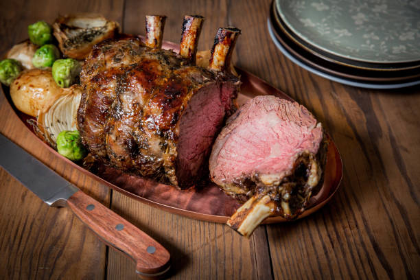 Rack of Lamb with one piece cut of. Rack of Lamb with one piece cut off. Served with baby potatoes and Brussel sprouts. lamb meat stock pictures, royalty-free photos & images