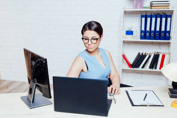 istock the girl works in an Office at a computer 1220300422