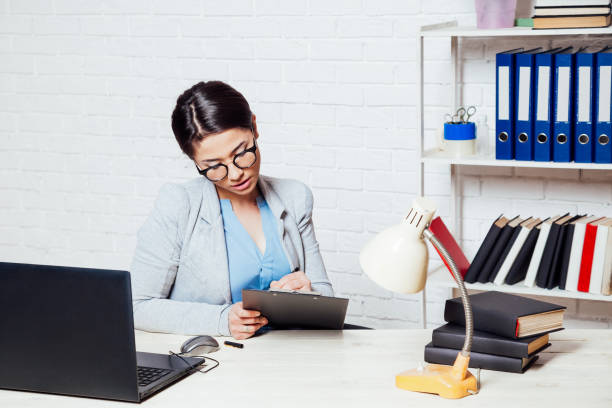 istock the girl works in an Office at a computer 1220300465