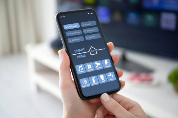 istock female hands holding phone with app smart home on screen 1220301034