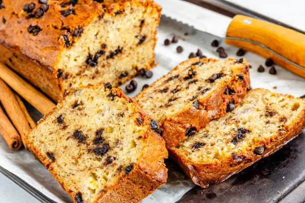 Banana Bread with Chocolate Chips on a Baking Sheet  with Knife