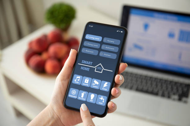 istock female hands holding phone with app smart home on screen 1220303115