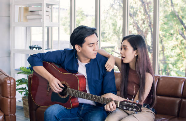 istock A man is playing guitar for his girlfriend 1220303169