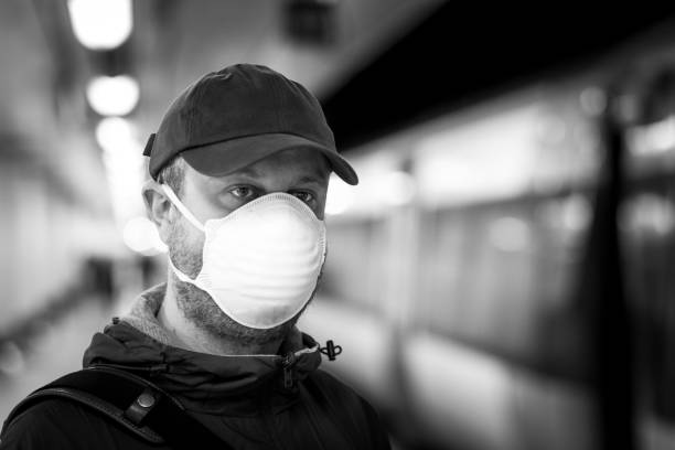 istock Man wearing protective face mask in city subway station 1220303236