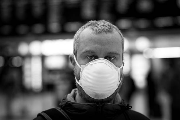 Man wearing protective face mask in city subway station