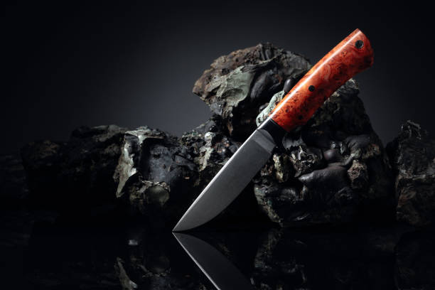 istock Hunter combat hand made knife and broken stones. 1220304120