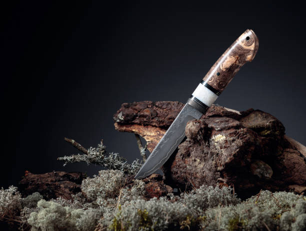 istock Hunter combat hand made knife. The surface of the blade - etching, traces of forging. Handle -  Japanese maple. 1220304127
