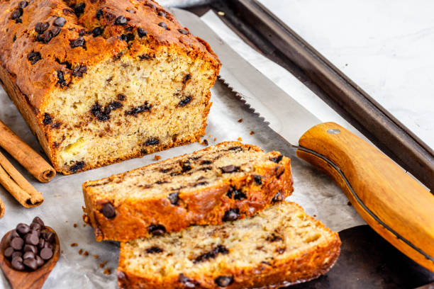 istock Banana Bread with Chocolate Chips on a Baking Sheet  with Knife 1220304415