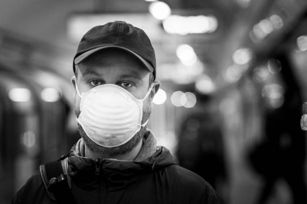 istock Man wearing protective face mask in city subway station 1220305538