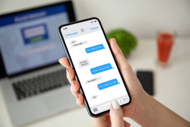 istock female hands holding phone with app messenger on the screen 1220305724