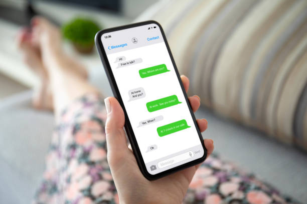 istock female hands on the sofa holding phone with app messenger 1220305902